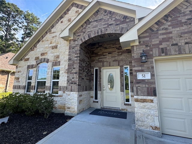 view of exterior entry with a garage