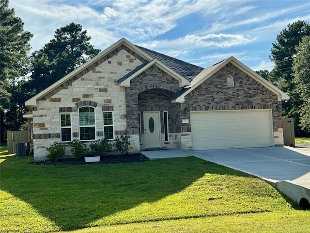 view of front facade featuring a front lawn, central AC, and a garage