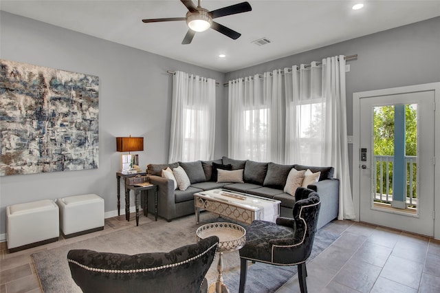 living room with ceiling fan and light tile patterned floors