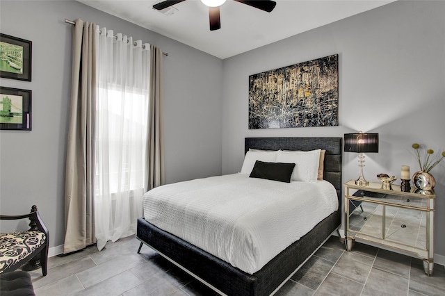 bedroom featuring tile patterned floors, multiple windows, and ceiling fan