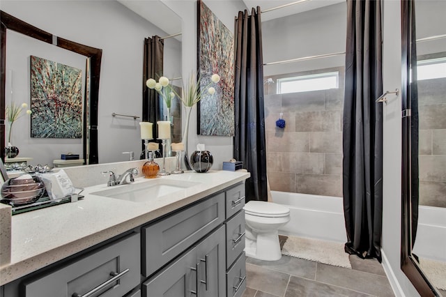 full bathroom with tile patterned floors, vanity, shower / tub combo, and toilet