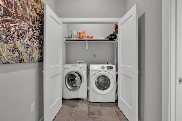 clothes washing area with washing machine and dryer