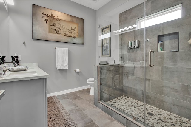 bathroom with vanity, an enclosed shower, and toilet