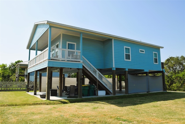 back of house featuring a patio area and a yard