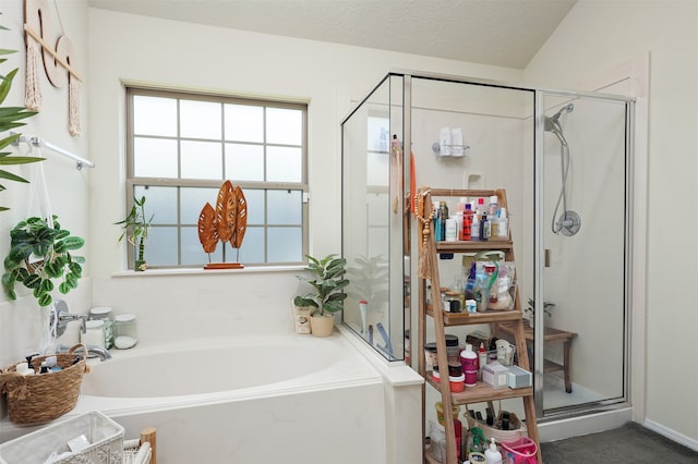 bathroom with a textured ceiling, vaulted ceiling, and independent shower and bath