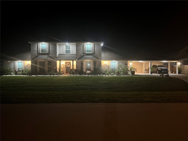 view of front of property with a yard and a carport