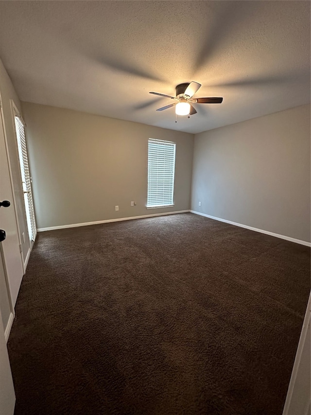 carpeted empty room with ceiling fan and a textured ceiling