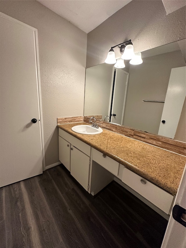 bathroom featuring hardwood / wood-style flooring and vanity