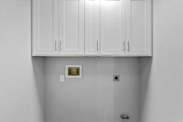 clothes washing area with hookup for an electric dryer, cabinets, and hookup for a washing machine