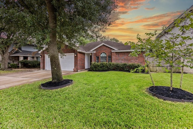 single story home featuring a garage and a yard