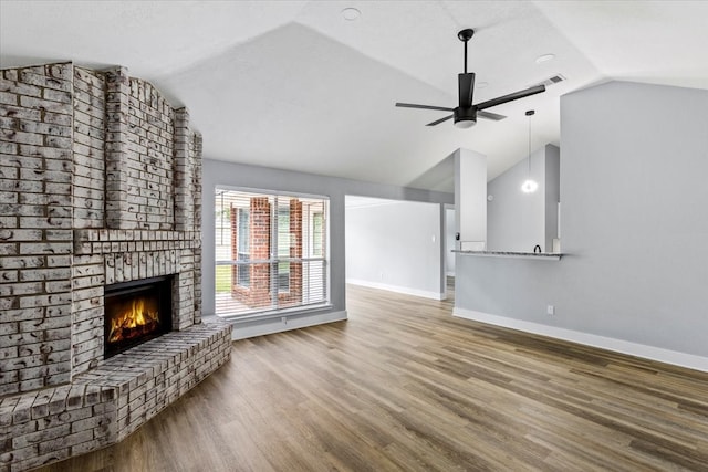 unfurnished living room featuring a fireplace, wood-type flooring, ceiling fan, and lofted ceiling