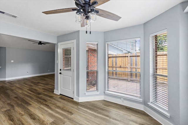 spare room with dark wood-type flooring