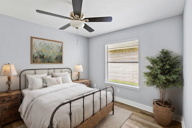 bedroom with light wood-type flooring and ceiling fan