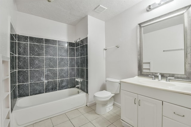 full bath featuring toilet, washtub / shower combination, vanity, a textured ceiling, and tile patterned flooring