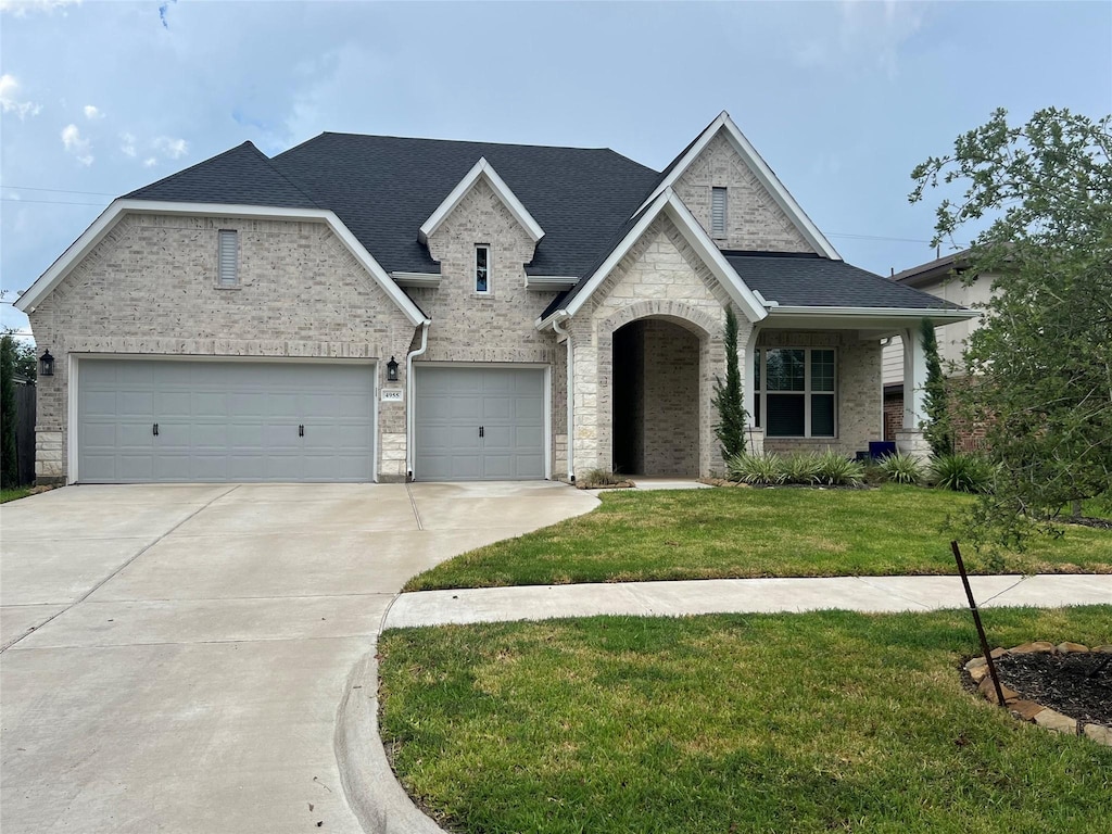 view of front of home with a garage and a front yard