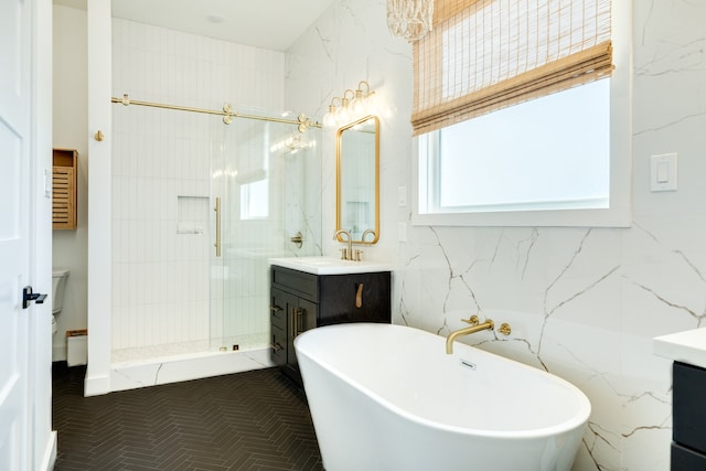 bathroom with tile patterned flooring, tile walls, separate shower and tub, and vanity