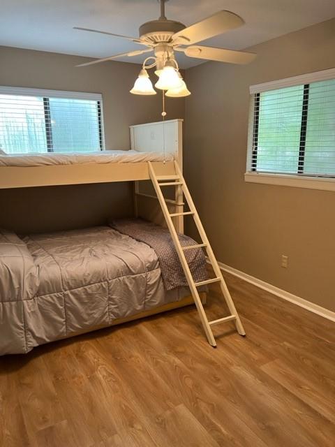 unfurnished bedroom featuring ceiling fan and hardwood / wood-style flooring