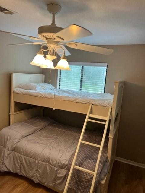 bedroom with hardwood / wood-style flooring and ceiling fan