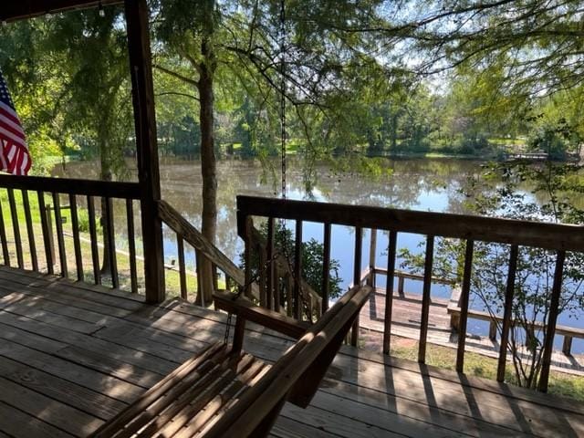 wooden terrace featuring a water view