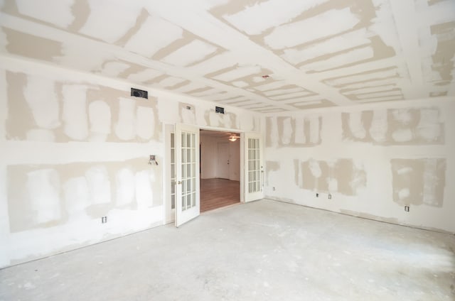 spare room with concrete floors and french doors