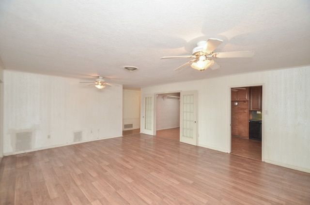 spare room featuring ceiling fan and light hardwood / wood-style floors