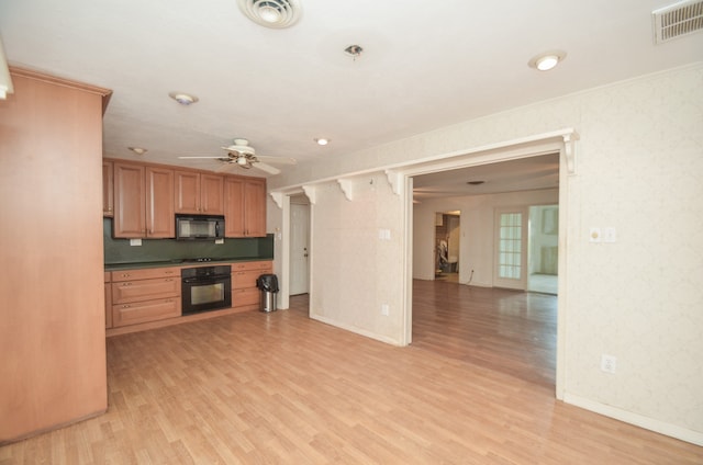 kitchen with light hardwood / wood-style floors, ceiling fan, and black appliances