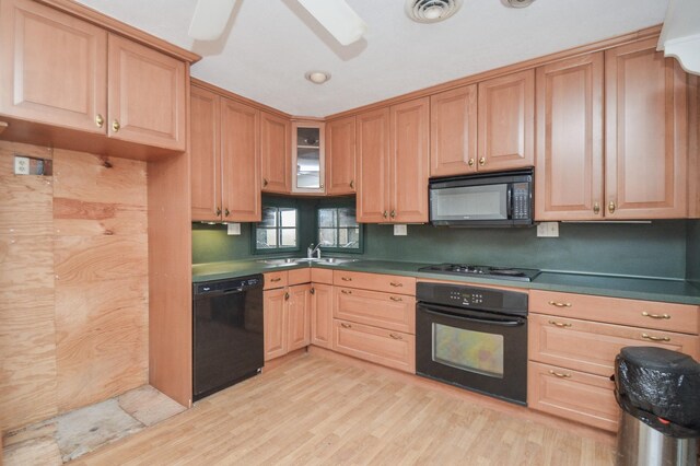 kitchen with sink, ceiling fan, light hardwood / wood-style floors, and black appliances