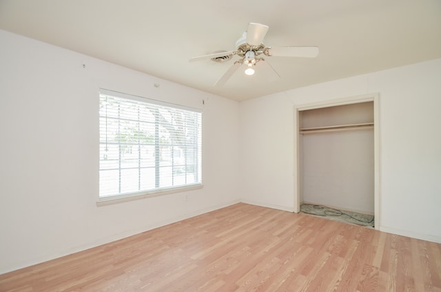 unfurnished bedroom featuring a closet, ceiling fan, and light wood-type flooring