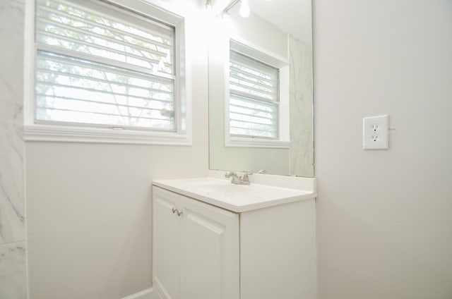 bathroom featuring a healthy amount of sunlight and vanity