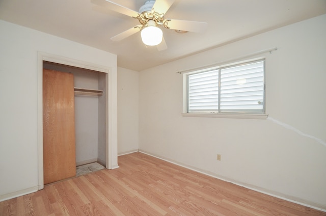 unfurnished bedroom featuring ceiling fan, a closet, and light hardwood / wood-style floors