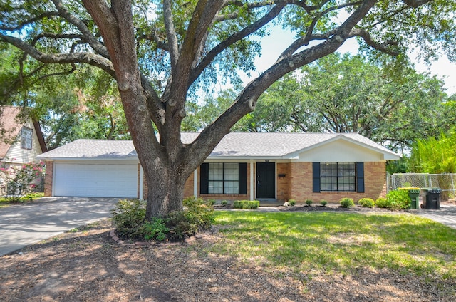 ranch-style home with a garage and a front lawn