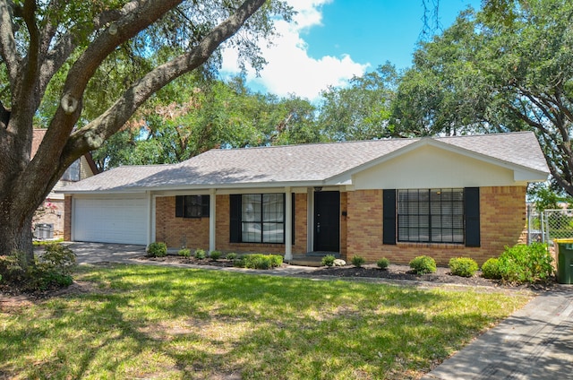 single story home featuring a garage and a front lawn