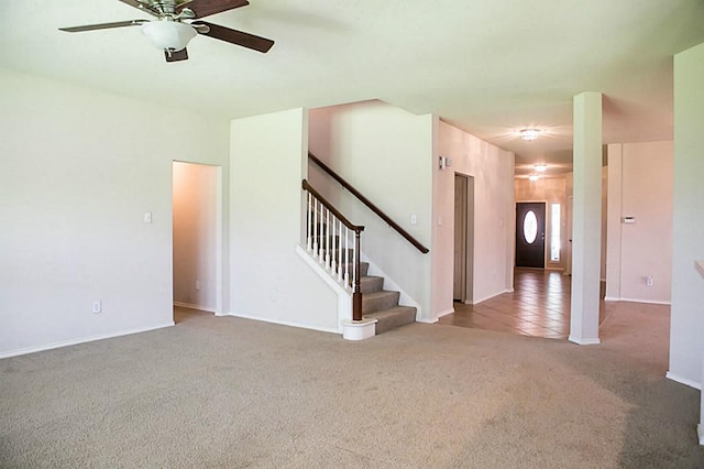 carpeted spare room with ceiling fan