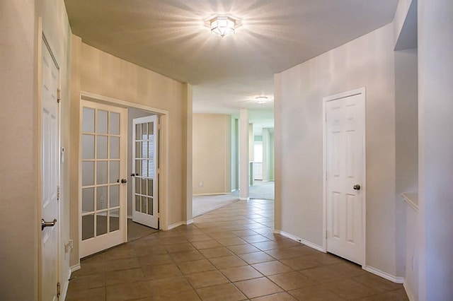 hallway featuring carpet and french doors