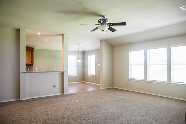 unfurnished living room featuring ceiling fan and light carpet