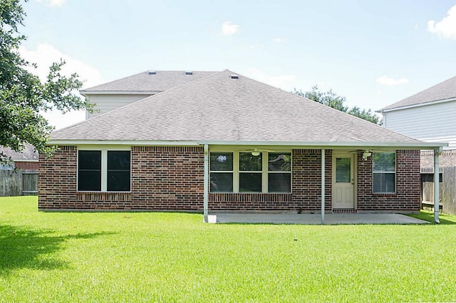 rear view of house featuring a patio and a lawn