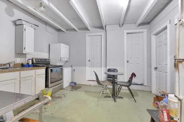 kitchen featuring beam ceiling, sink, electric range, and white cabinets