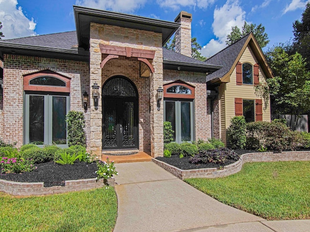 view of front facade featuring a front yard and french doors