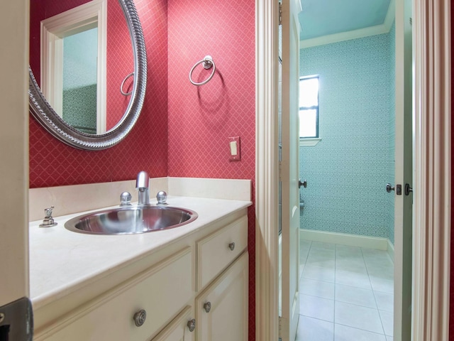 bathroom featuring wallpapered walls, tile patterned flooring, ornamental molding, and vanity