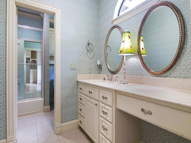 bathroom featuring tile patterned flooring, vanity, and bath / shower combo with glass door