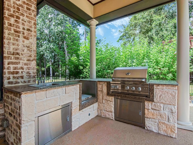 view of patio featuring area for grilling and sink