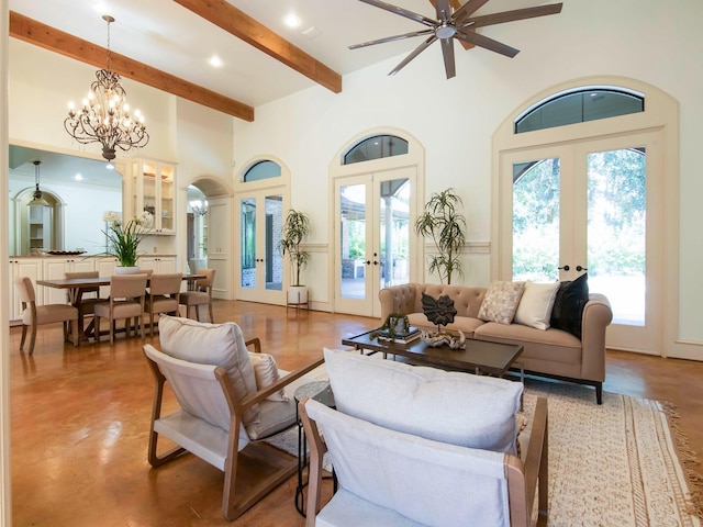 living room with a chandelier, a high ceiling, concrete floors, french doors, and beamed ceiling