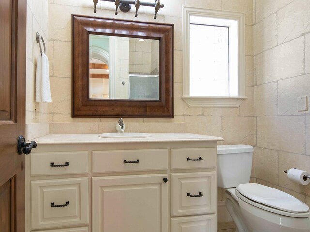 bathroom featuring toilet and vanity