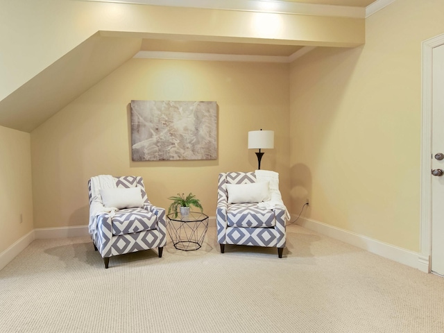 sitting room featuring carpet floors, lofted ceiling with beams, and baseboards