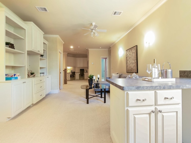 kitchen featuring visible vents, open shelves, a ceiling fan, and light colored carpet