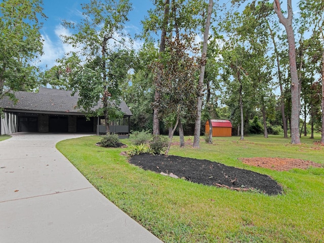 view of front of property with an outbuilding, an attached garage, a storage shed, driveway, and a front lawn