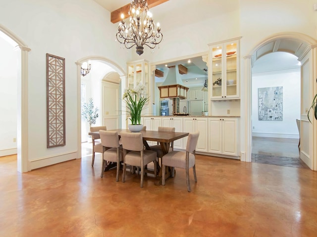 dining space with a chandelier, arched walkways, finished concrete flooring, and a high ceiling