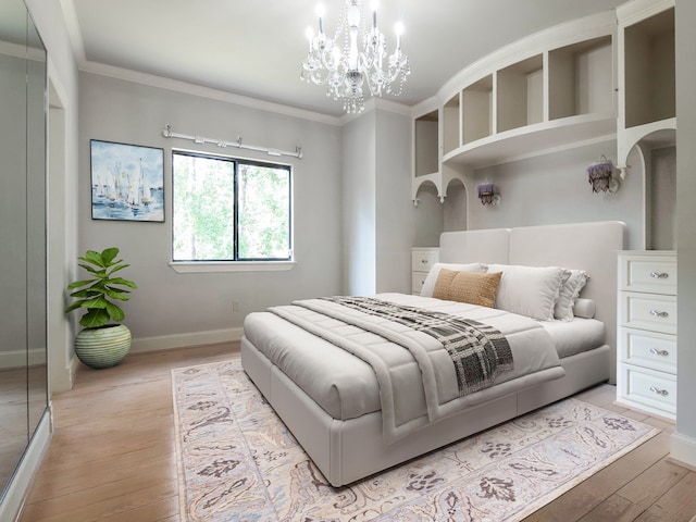 bedroom featuring a chandelier, crown molding, and light hardwood / wood-style flooring