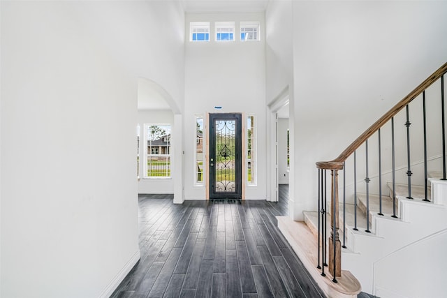 16518 Boston Post Rd, Cypress, TX 77429 - entryway featuring arched walkways, dark wood-type flooring, a high ceiling, and stairway