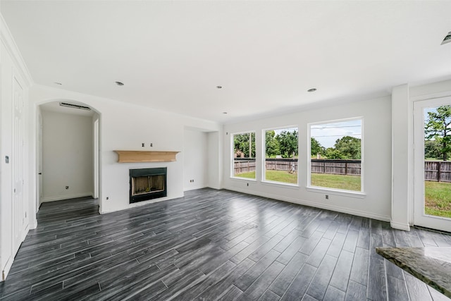 16518 Boston Post Rd, Cypress, TX 77429 - unfurnished living room featuring dark wood finished floors, a fireplace, and arched walkways
